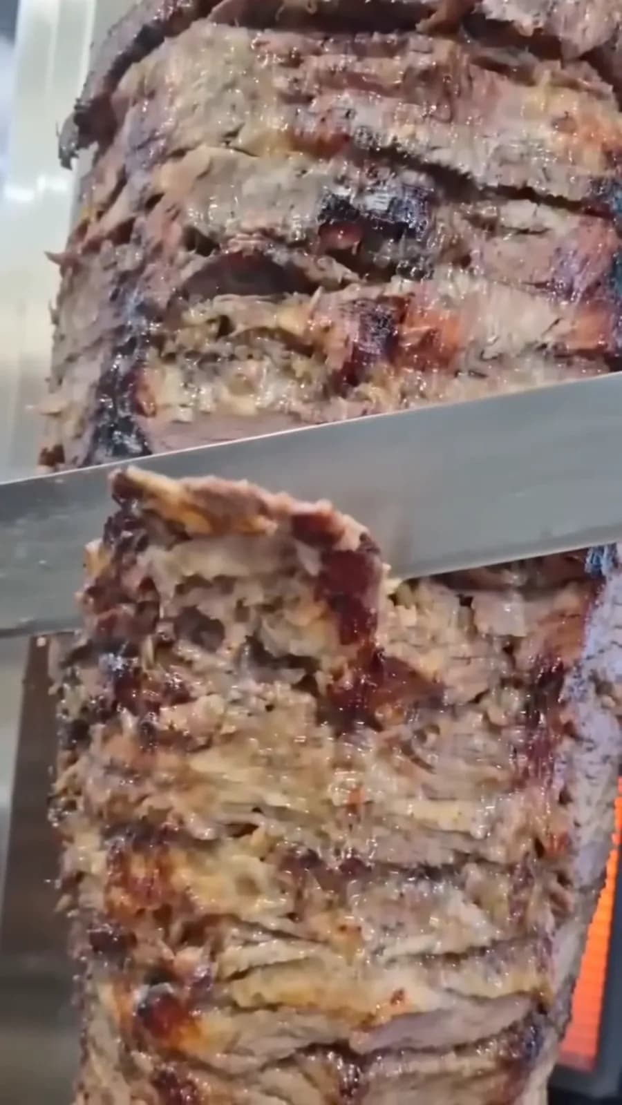 Beef shawarma being carved from the spit