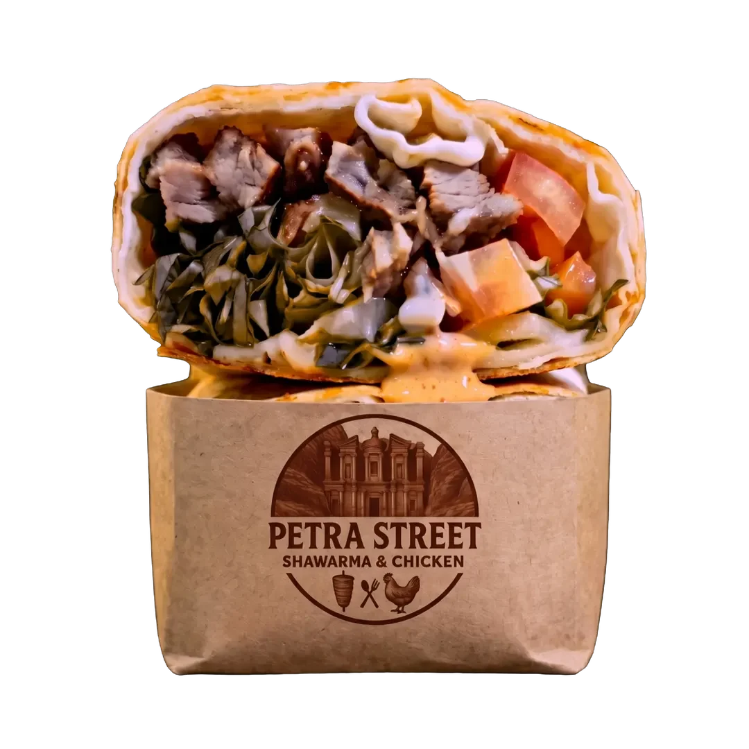 Petra Street shawarma wrap, cut in half, in a branded kraft sleeve, turning
